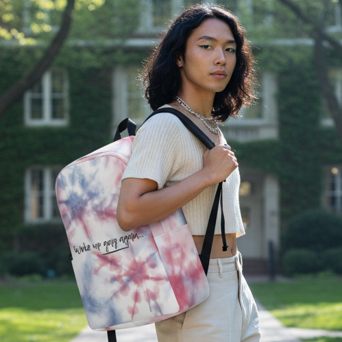 Woke Up Gay Again Minimalist Backpack slung on a person in a cream crop top and beige pants, strolling a sunny campus