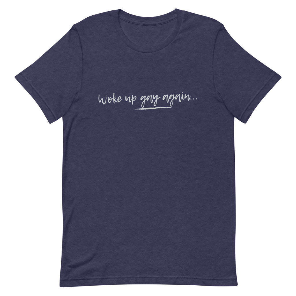 Unisex navy blue tee with "Woke Up Gay Again" in bold white cursive, laid flat showing front and sleeves on a white backdrop.
