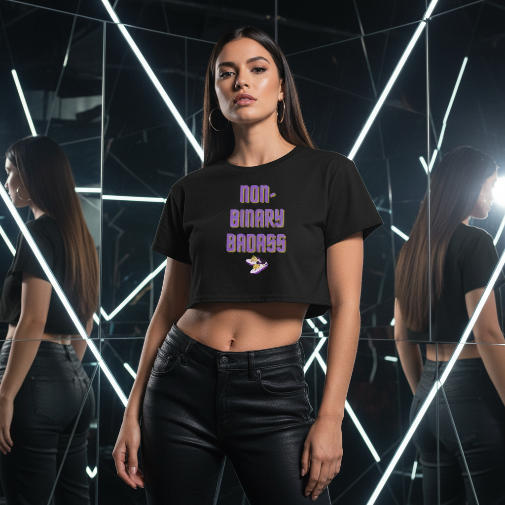 Non-Binary Badass Crop Top in black with bold purple “Non-Binary Badass” text, styled with black pants; wearer looks fierce.