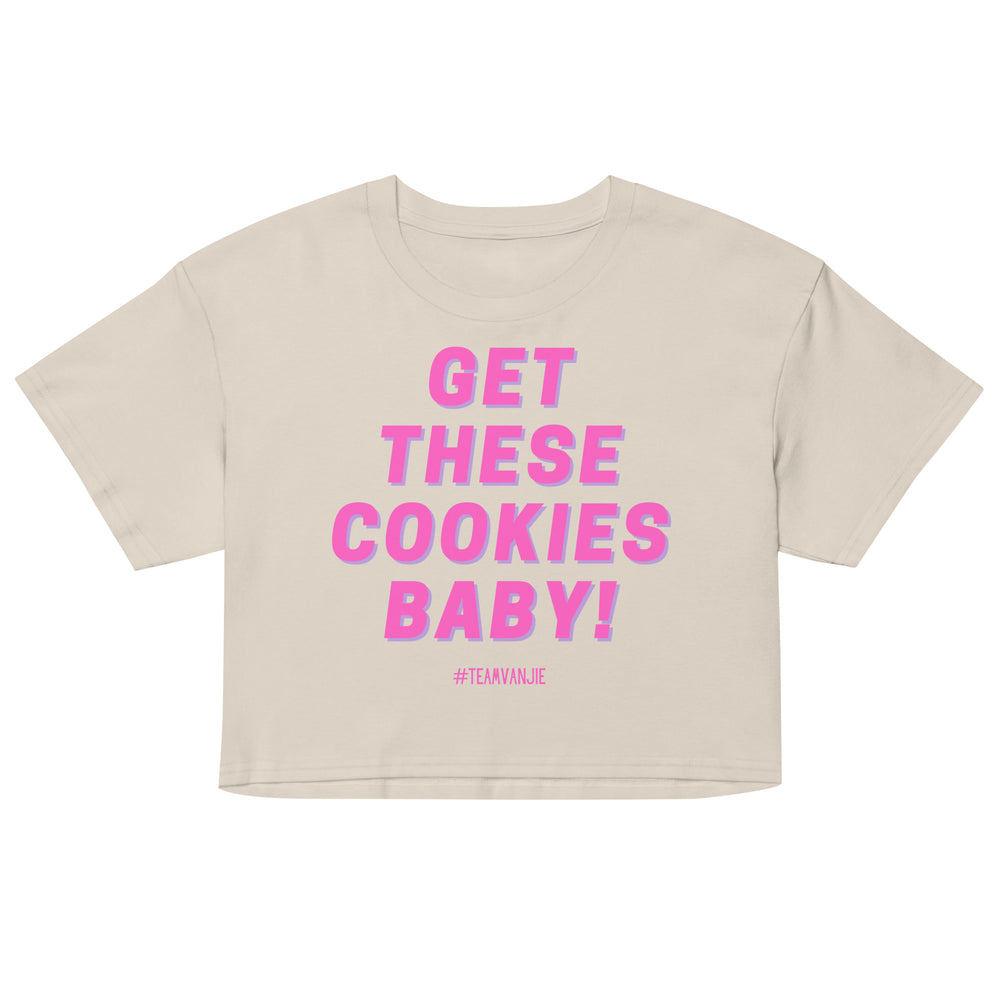 Front view of a cream crop top reading “GET THESE COOKIES BABY!” in pink