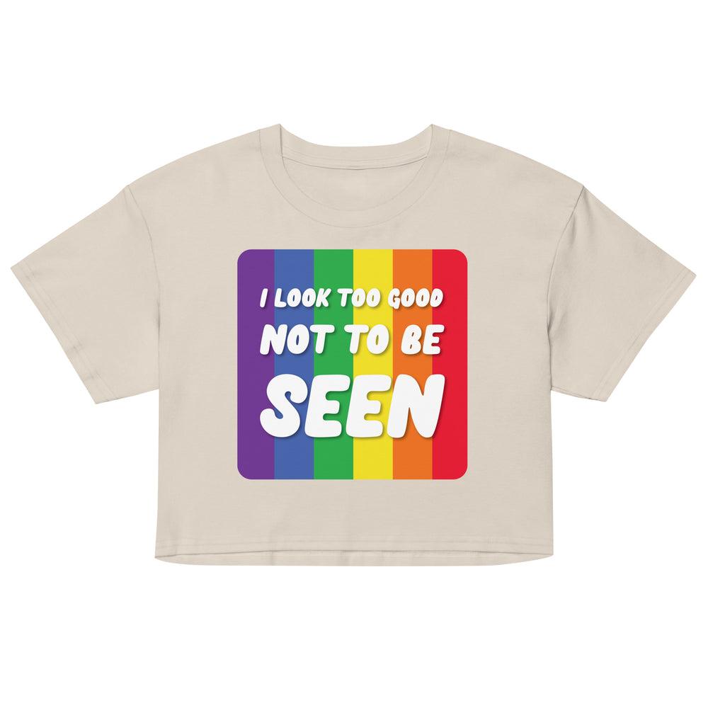 Front-facing beige crop top with rainbow stripes and the text “I LOOK TOO GOOD NOT TO BE SEEN”