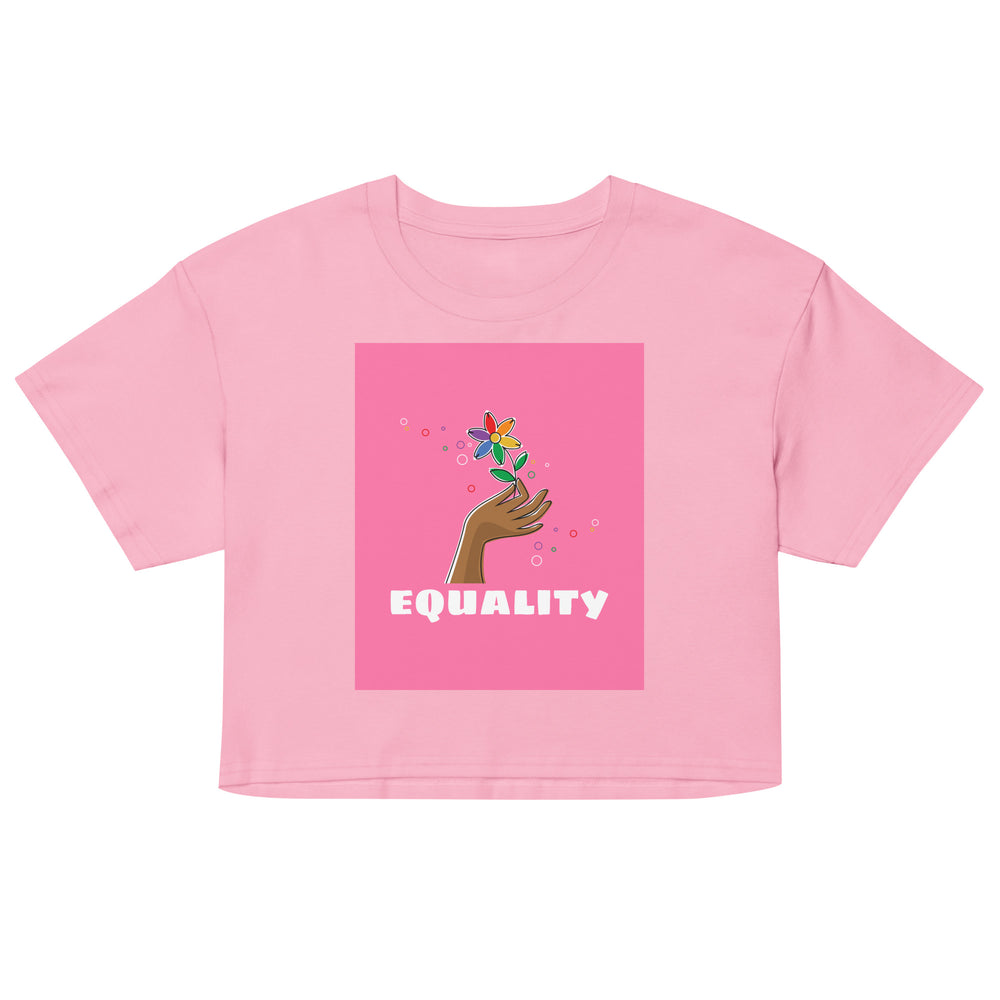 Front view of a pink crop top with a hand holding a flower above the word “EQUALITY”