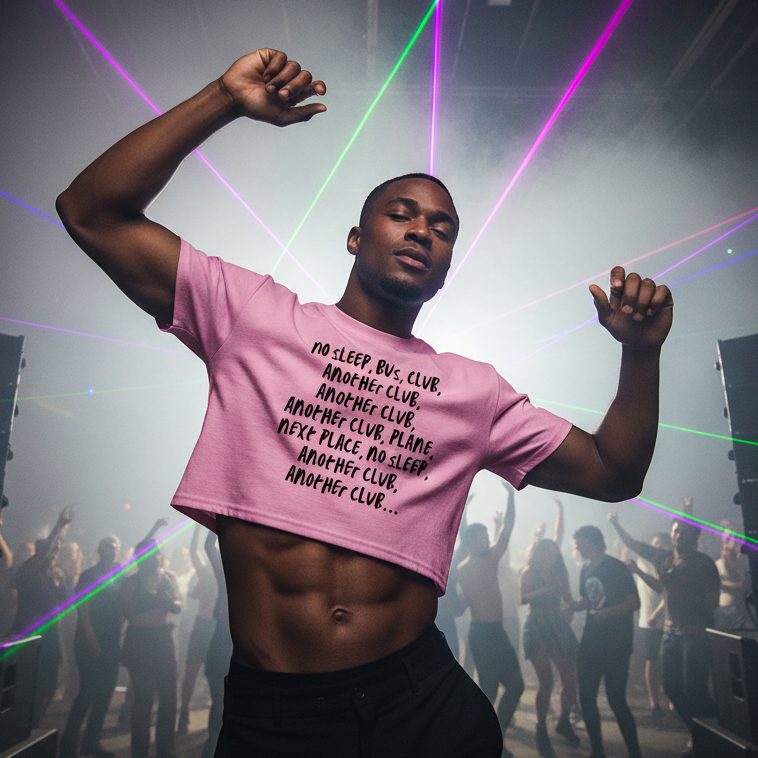A young man dances confidently in a nightclub wearing the No Sleep, Bus, Club, Another Club Crop Top, celebrating queer pride with its bold mantra, relaxed fit, and empowering cropped design.