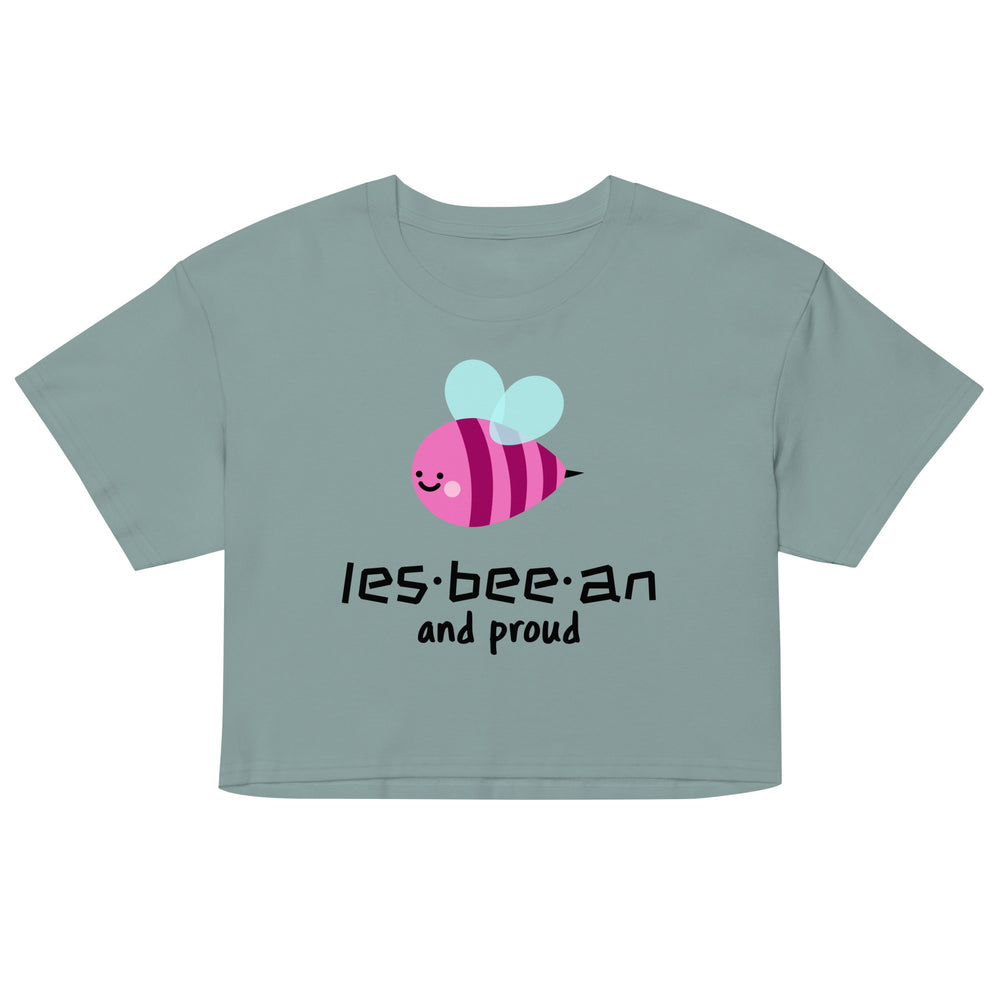 Front view of a sage-green crop top with a smiling pink bee and “les-bee-an and proud” text