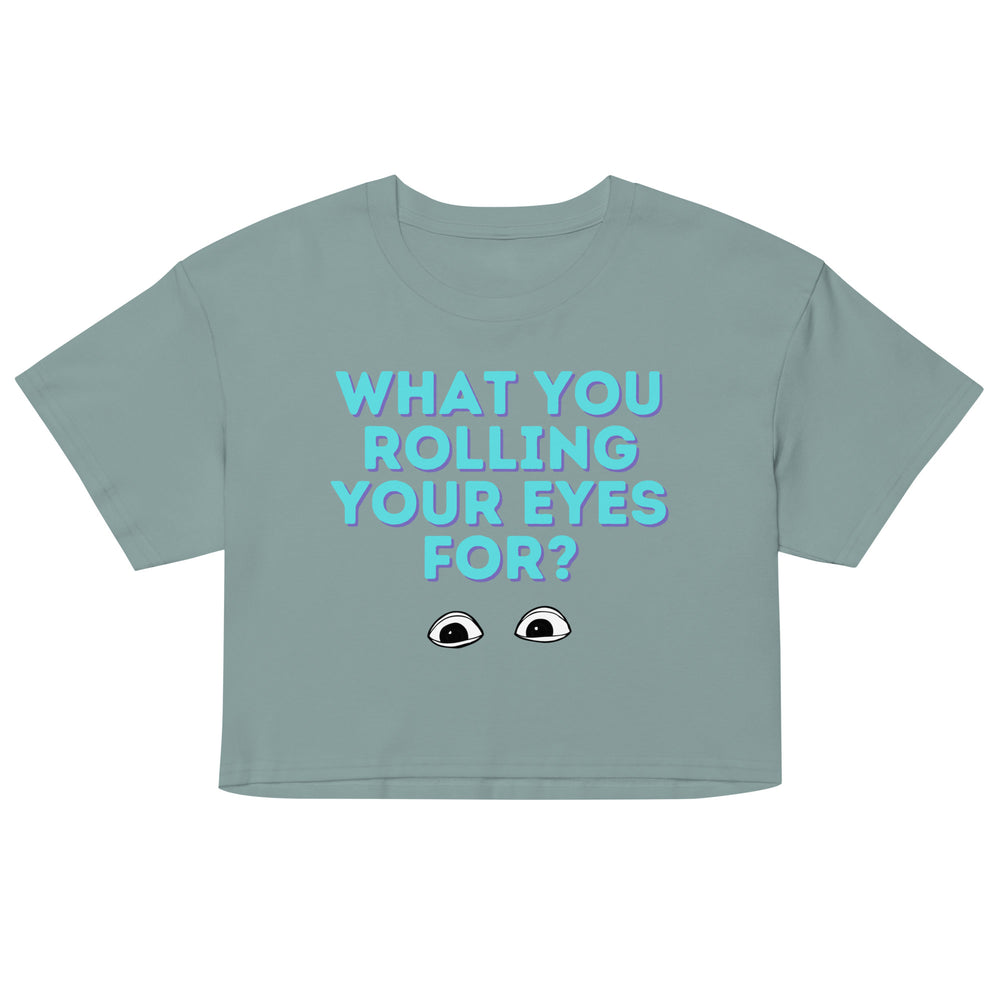 Front view of a sage green cropped T-shirt reading “WHAT YOU ROLLING YOUR EYES FOR?”