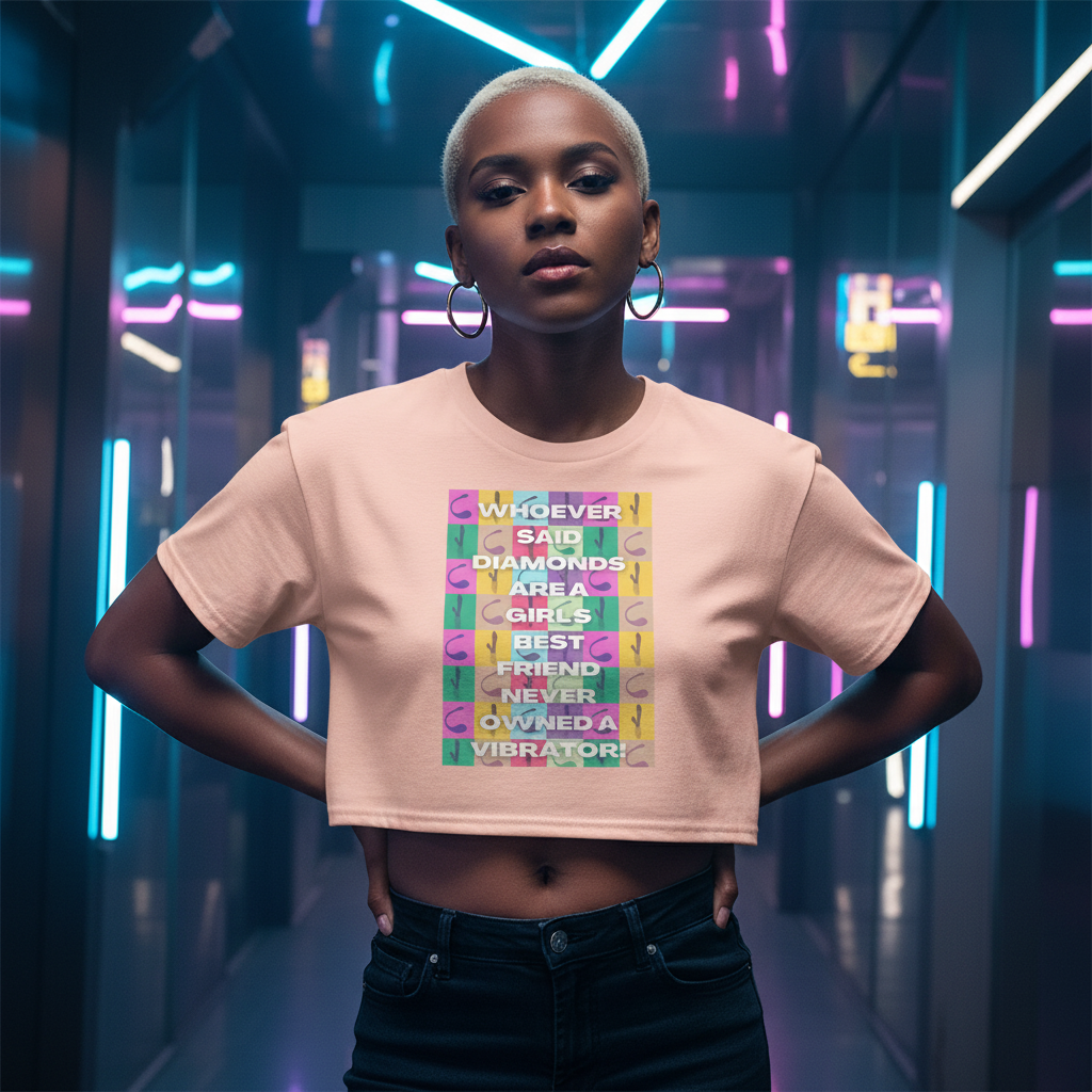 Never Owned A Vibrator Crop Top with slogan “Whoever said diamonds are a girl’s best friend never owned a vibrator,” modeled by a bold young woman with short blond hair posing in neon lights.