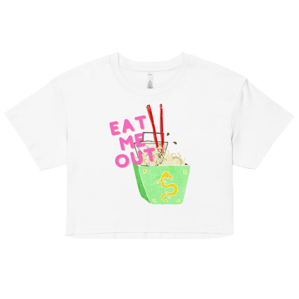 White crop top with pink “EAT ME OUT” text and a colorful noodle bowl graphic