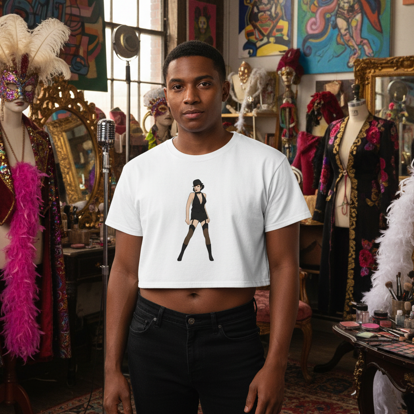 A young person in a theatrical studio wears the Liza Minnelli Crop Top featuring a cabaret-style dancer. Surrounded by flamboyant costumes, embodying queer expression and empowerment.