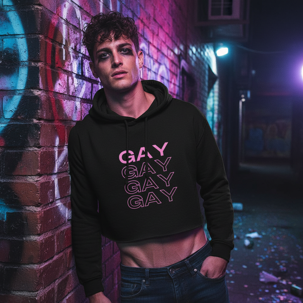Gay Gay Gay Crop Hoodie with “GAY” in pink, worn by a queer guy in bold makeup, serving looks under neon in a graffiti alley.