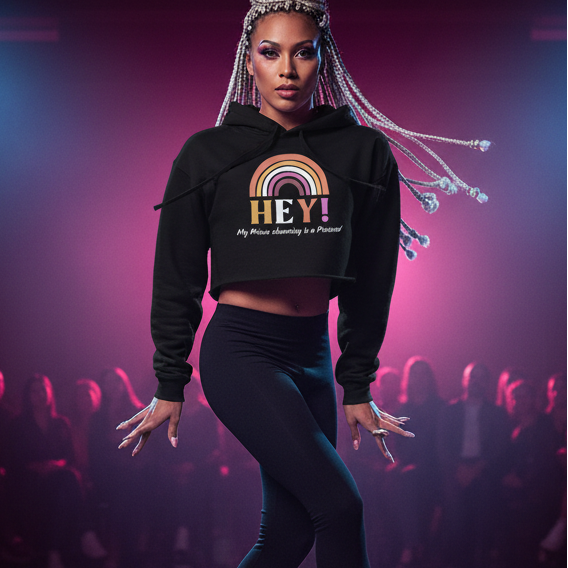 Black crop hoodie reading "Hey! My Prince Charming Is A Princess!" on a model with platinum braids, strutting under pink lights.