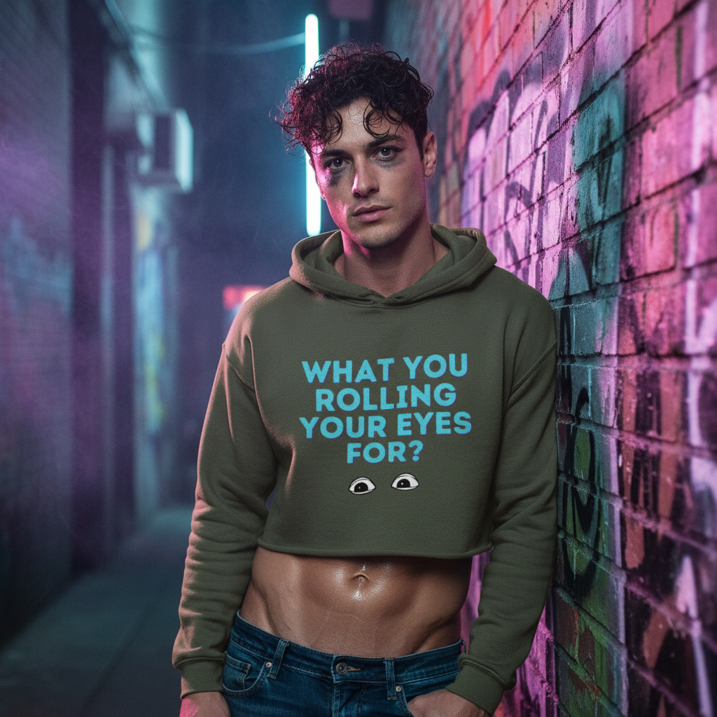 Olive green "What You Rolling Your Eyes For?" crop hoodie with blue text and eye graphics, worn in neon-lit queer alley scene.