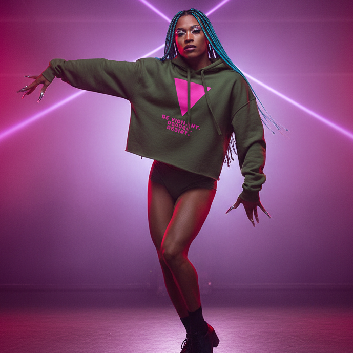Olive green crop hoodie with “Be Vigilant. Refuse. Resist.” and pink triangle, worn by a queer dancer in bold neon-lit style.