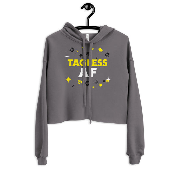 Front view of a gray cropped hoodie on a hanger with yellow and white “TAGLESS AF” text