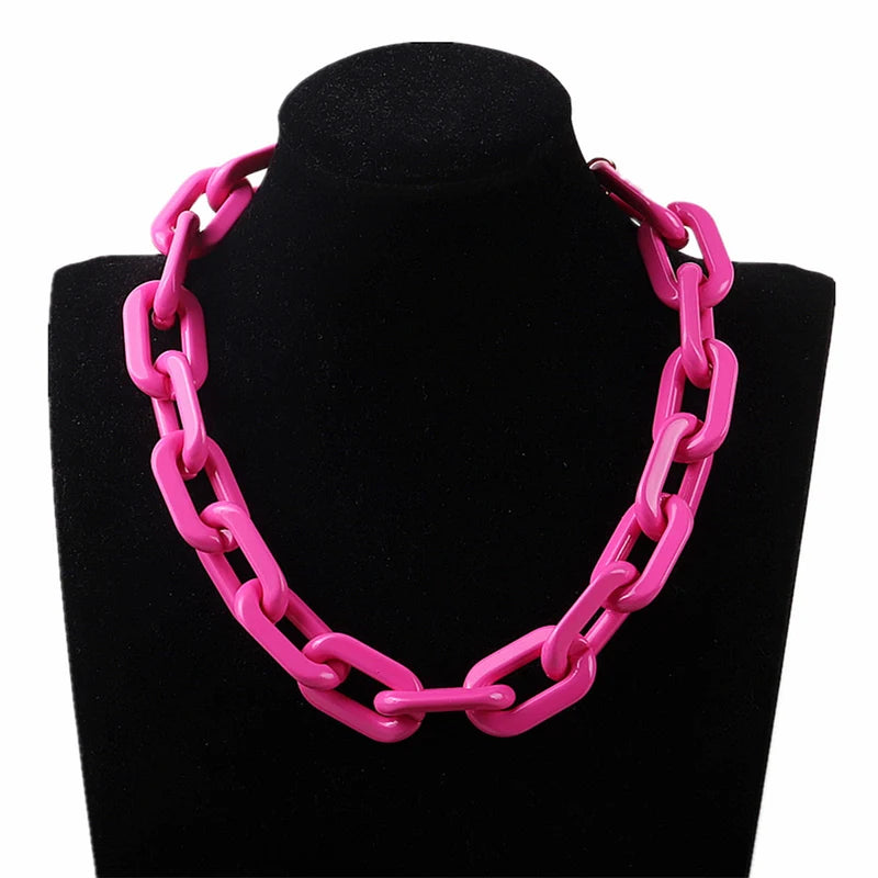 Bright pink chunky chain necklace displayed on a black jewelry bust