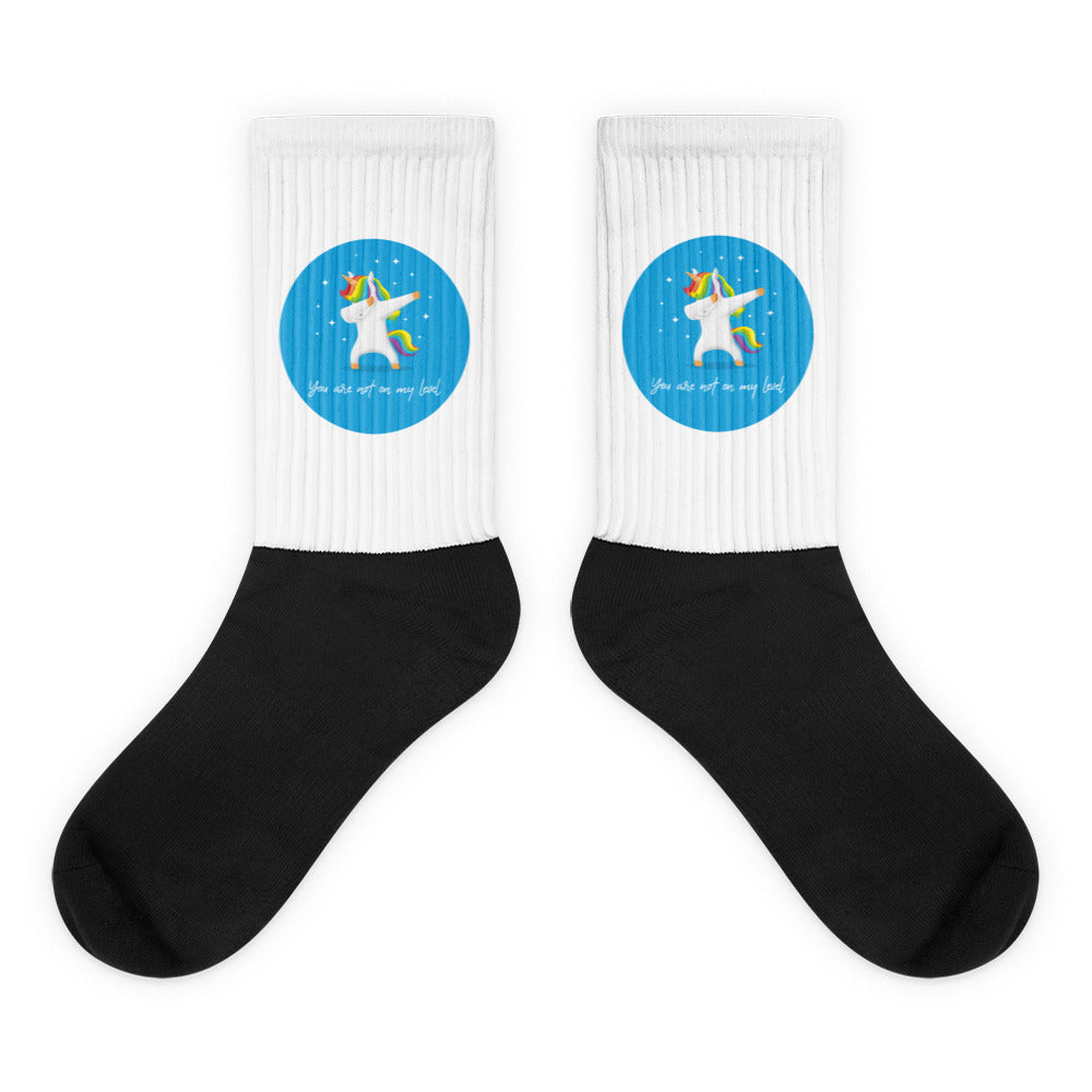 You Are Not On My Level Socks feature a dabbing unicorn within a turquoise circle on white, with a bold black foot