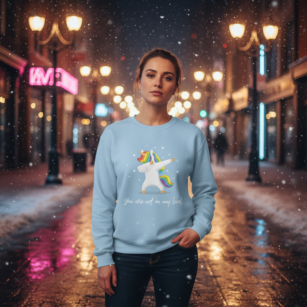 Person wearing a light-blue sweatshirt with a dab-unicorn graphic and “You are not on my level” text in a snowy city street