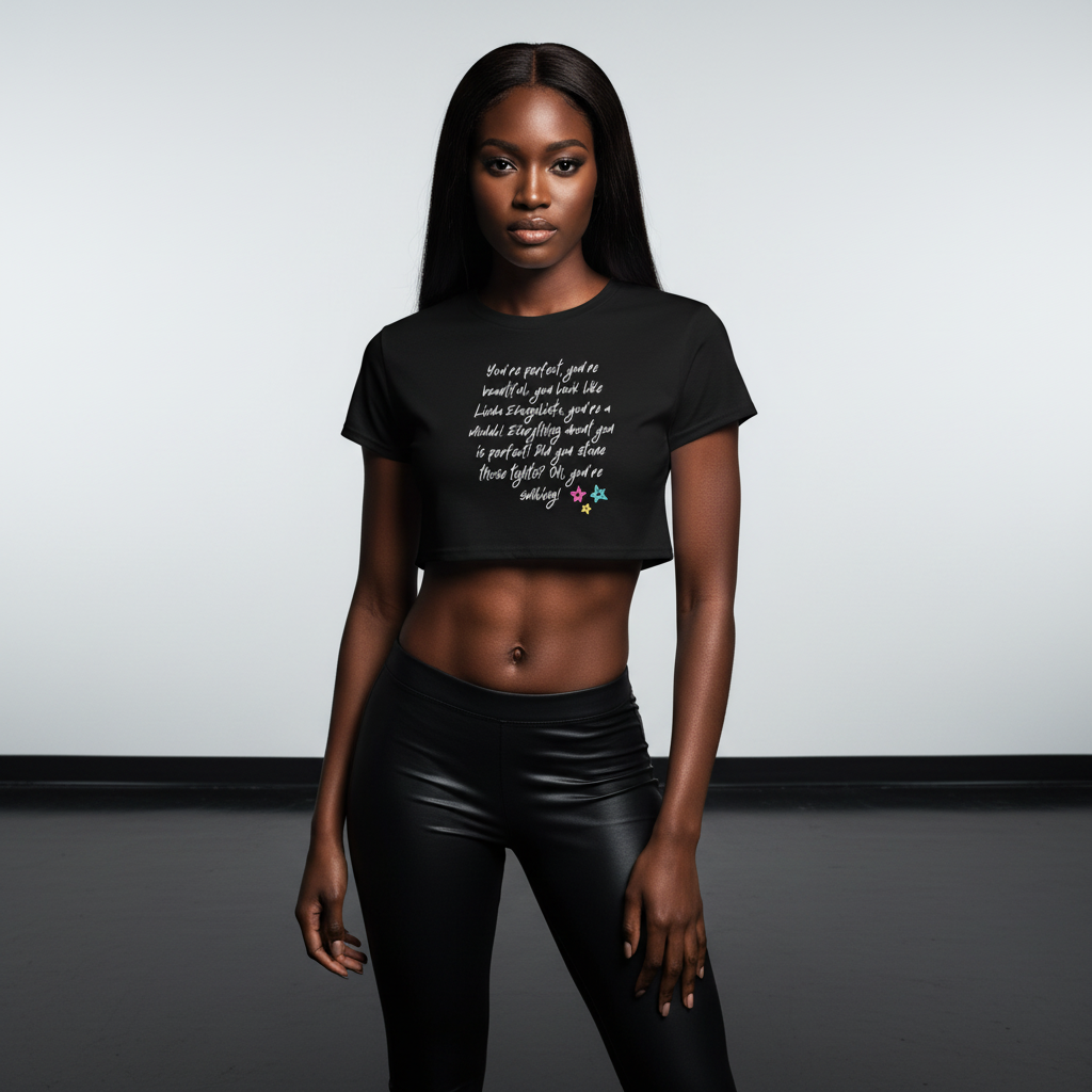 Crop top with bold white "You Look Like Linda Evangelista" text and rainbow stars, worn with black leggings; model, studio