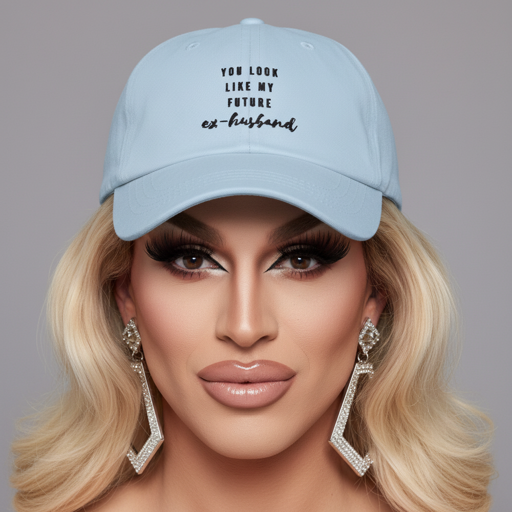 Light blue cap reading “YOU LOOK LIKE MY FUTURE ex-husband,” worn in a close-up portrait