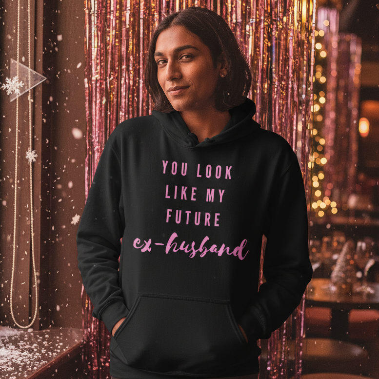 Model wearing a black hoodie reading “YOU LOOK LIKE MY FUTURE EX-HUSBAND” in pink