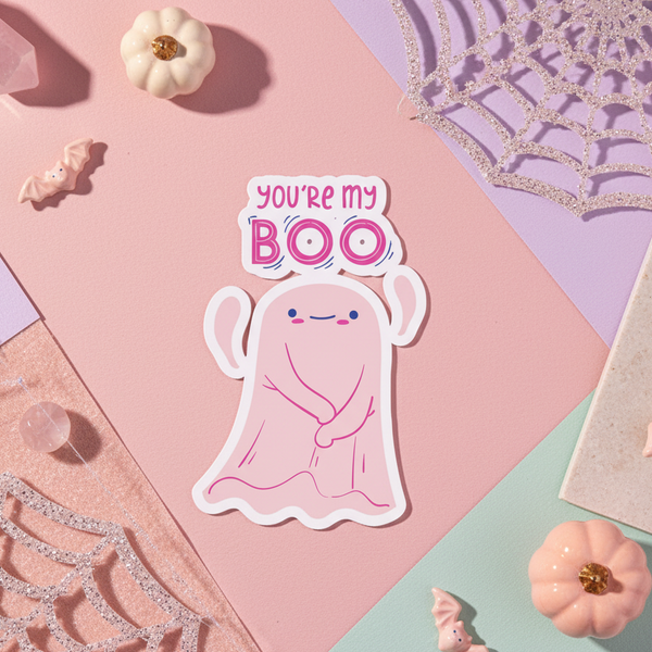 Bubble-free sticker with a pink ghost smiling and raising its arms on a pastel vibe, ringed by pumpkins, bats, crystals