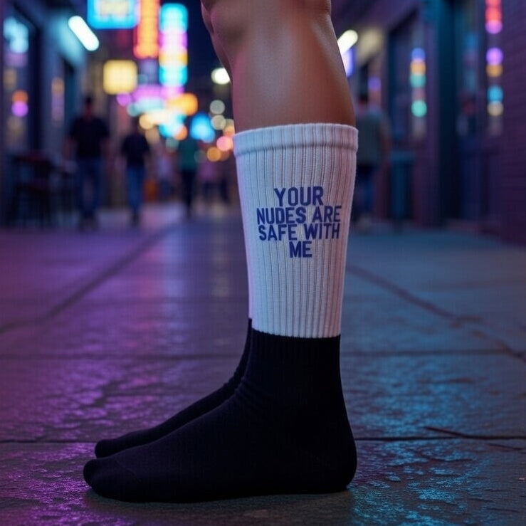 Crew socks reading “Your Nudes Are Safe With Me,” with bold art, blue text, and black toes and heels