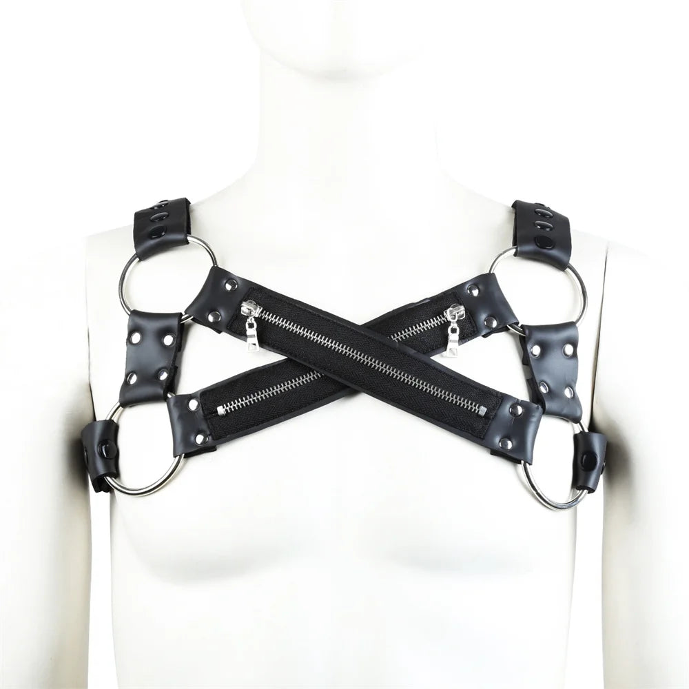 Front view of a black faux-leather chest harness with crossed zippered straps and metal rings