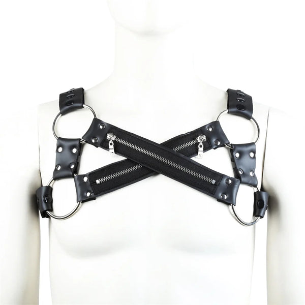 Front view of a black faux-leather chest harness with crossed zippered straps and metal rings