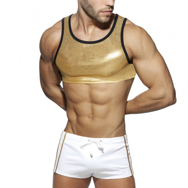 Cropped model wearing a metallic gold crop tank and white shorts with gold trim