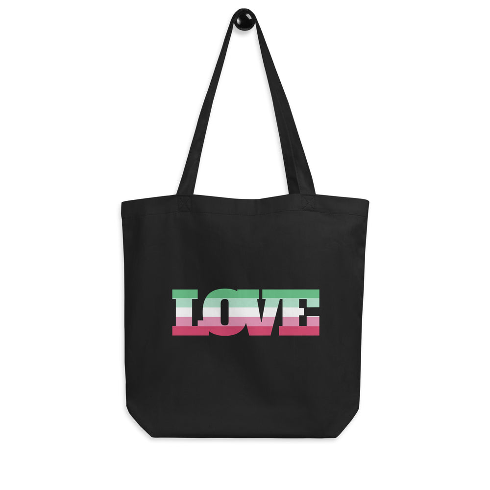 Front-facing black tote bag with long handles and colorful striped “TOTE” lettering