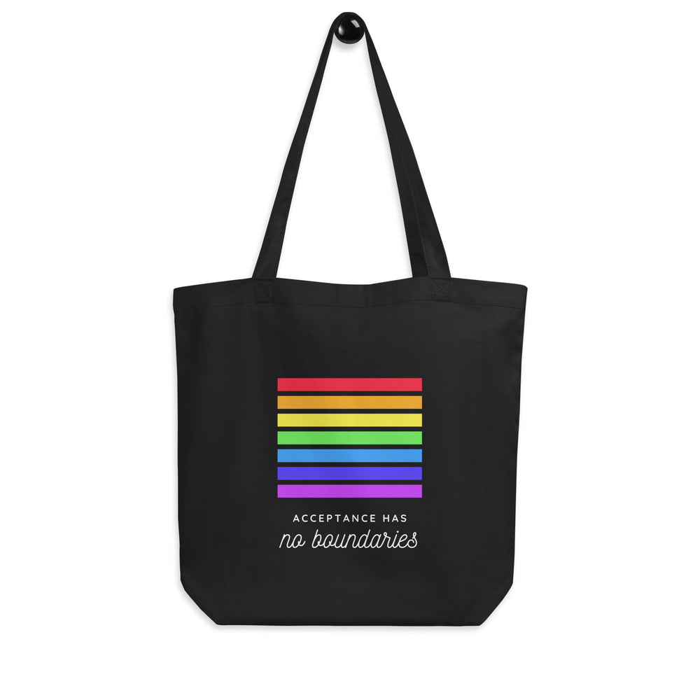 Front view of a black tote bag with rainbow stripes and “Acceptance Has no boundaries” text