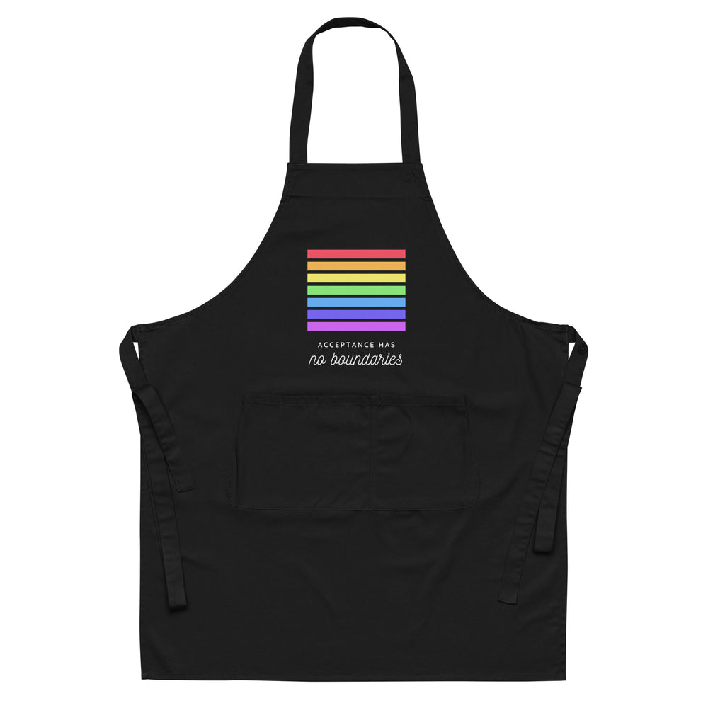 Front-view black apron with rainbow stripes, two pockets, and “Acceptance has no boundaries” text
