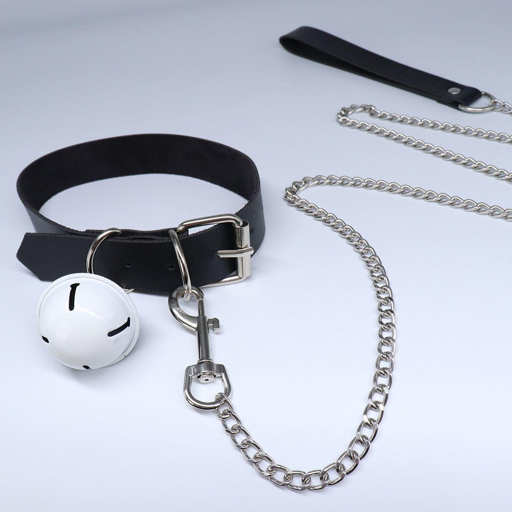 Black adjustable collar with silver chain leash and white bell, shown in a product close-up