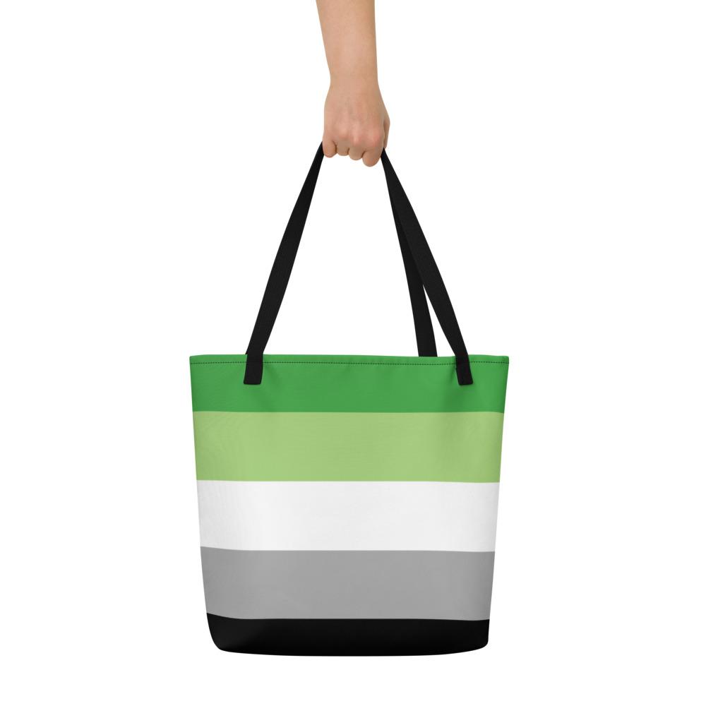 Front view of a black-handled tote with horizontal green, white, gray, and black stripes