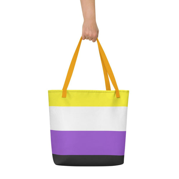 Striped non-binary pride tote bag with orange straps, held against a white background