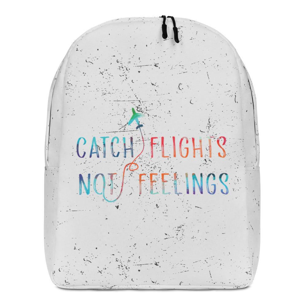 Front view of a white speckled backpack reading “CATCH FLIGHTS NOT FEELINGS” in rainbow lettering