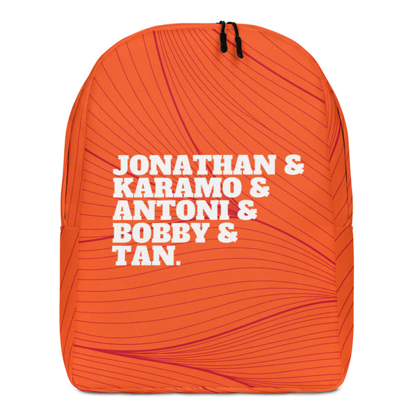 Front view of an orange backpack with burgundy lines and white names: Jonathan, Karamo, Antoni, Bobby, and Tan