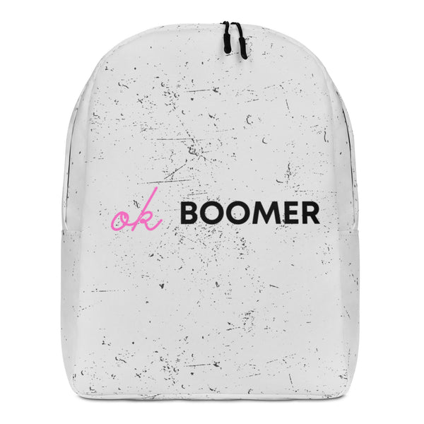 Front view of a white speckled backpack with pink script and bold black “BOOMER” text
