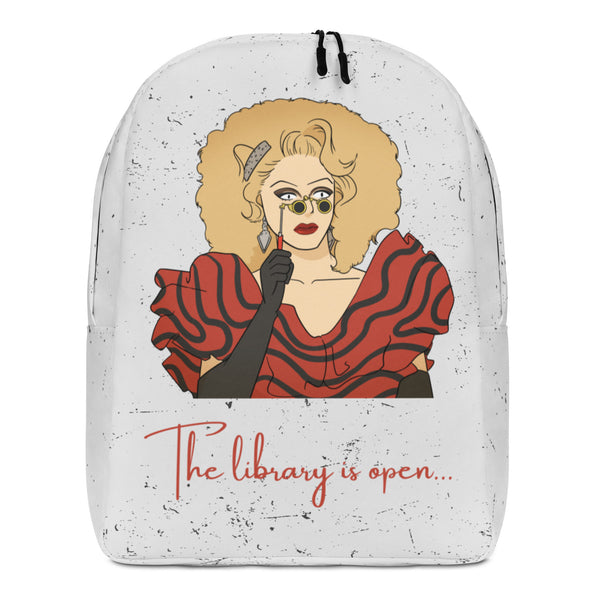 Front view of a white speckled backpack featuring a drag queen illustration and “The library is open...”