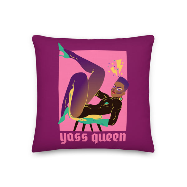 Close-up of a purple pillow featuring a drag performer illustration and “Yass Queen” text