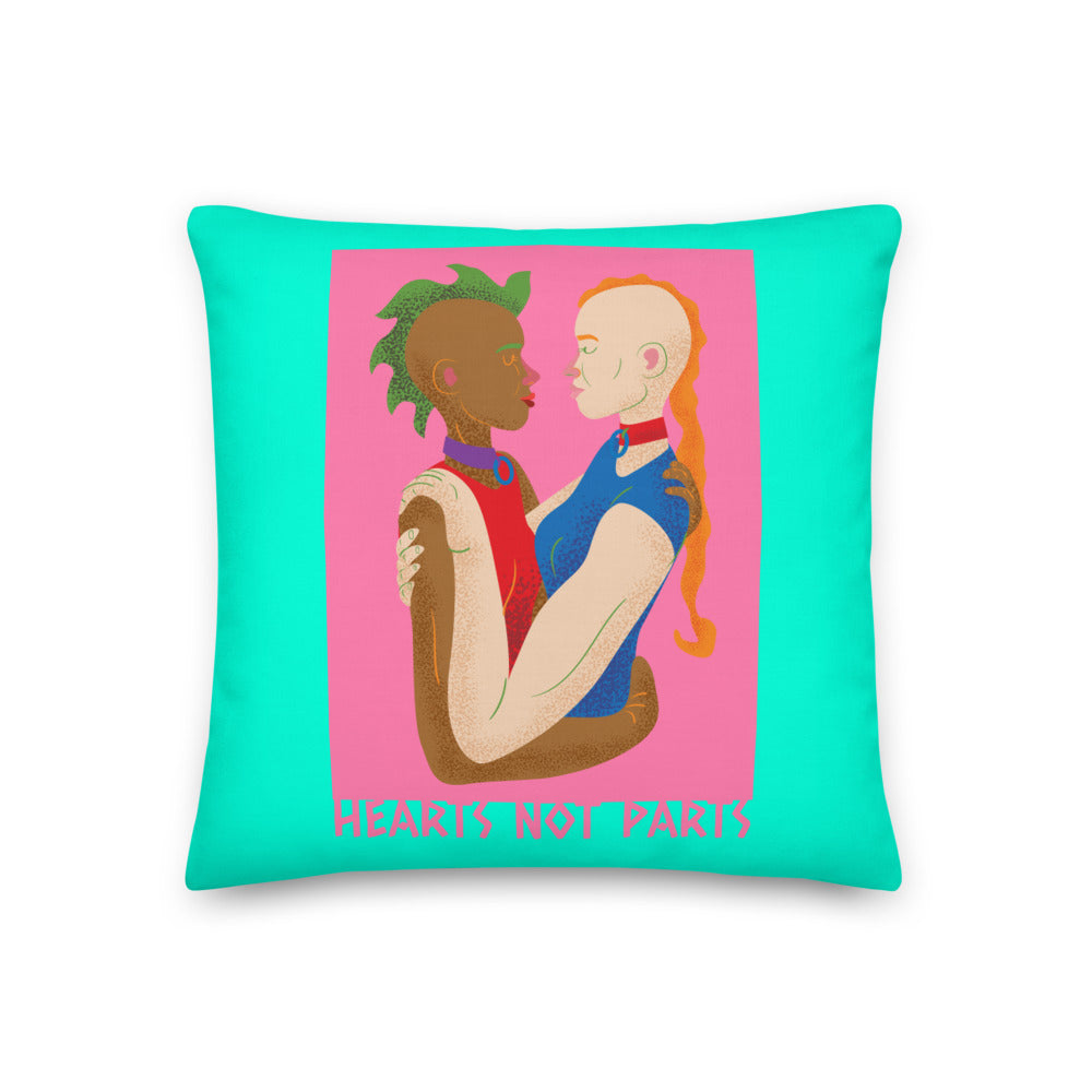 Turquoise pillow featuring two embracing figures and the text “HEARTS NOT PARTS”