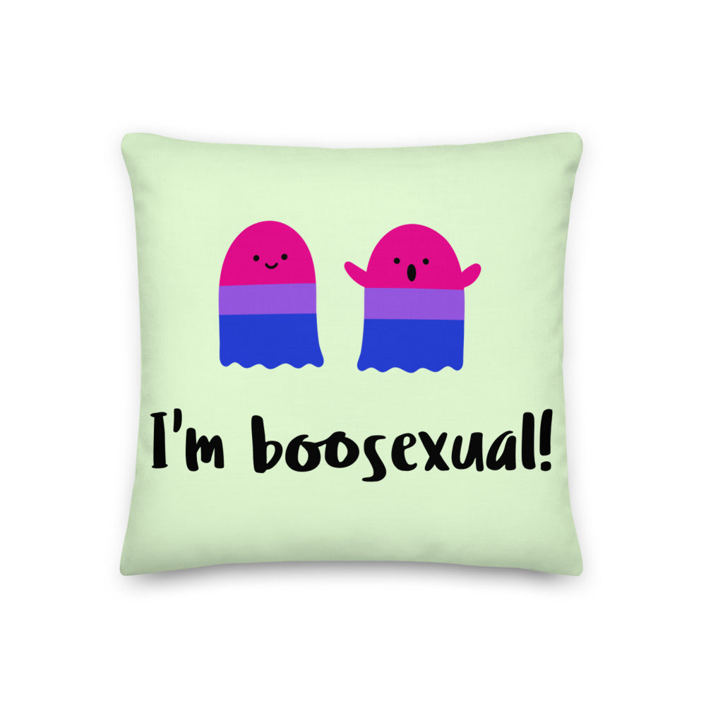 Light green pillow with two pink, purple, and blue ghost characters and “I’m boosexual!” text