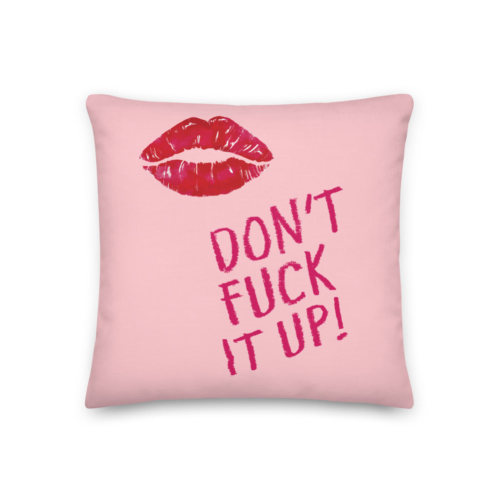 Pink square pillow with red lips and the slogan “DON’T FUCK IT UP!”