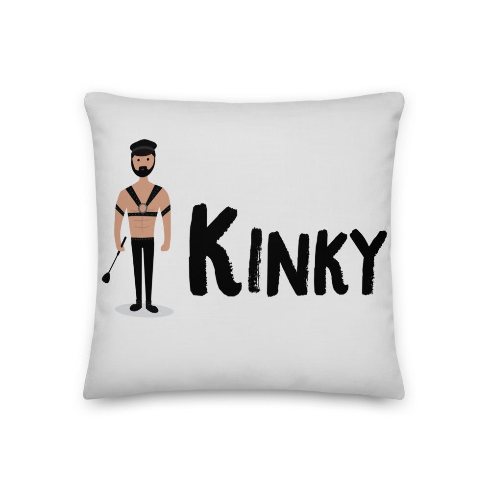White square pillow featuring a bearded leather-clad figure, riding crop, and the word “KINKY”