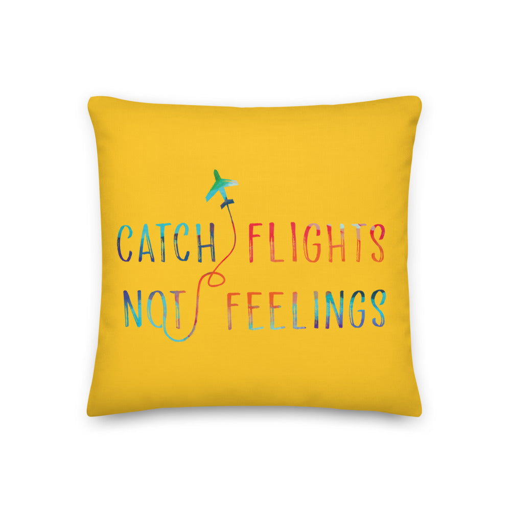 Yellow pillow with colorful airplane graphic and the slogan “CATCH FLIGHTS NOT FEELINGS”