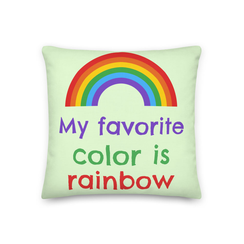 Rainbow pillow with the slogan “My favorite color is rainbow” on a pale green background