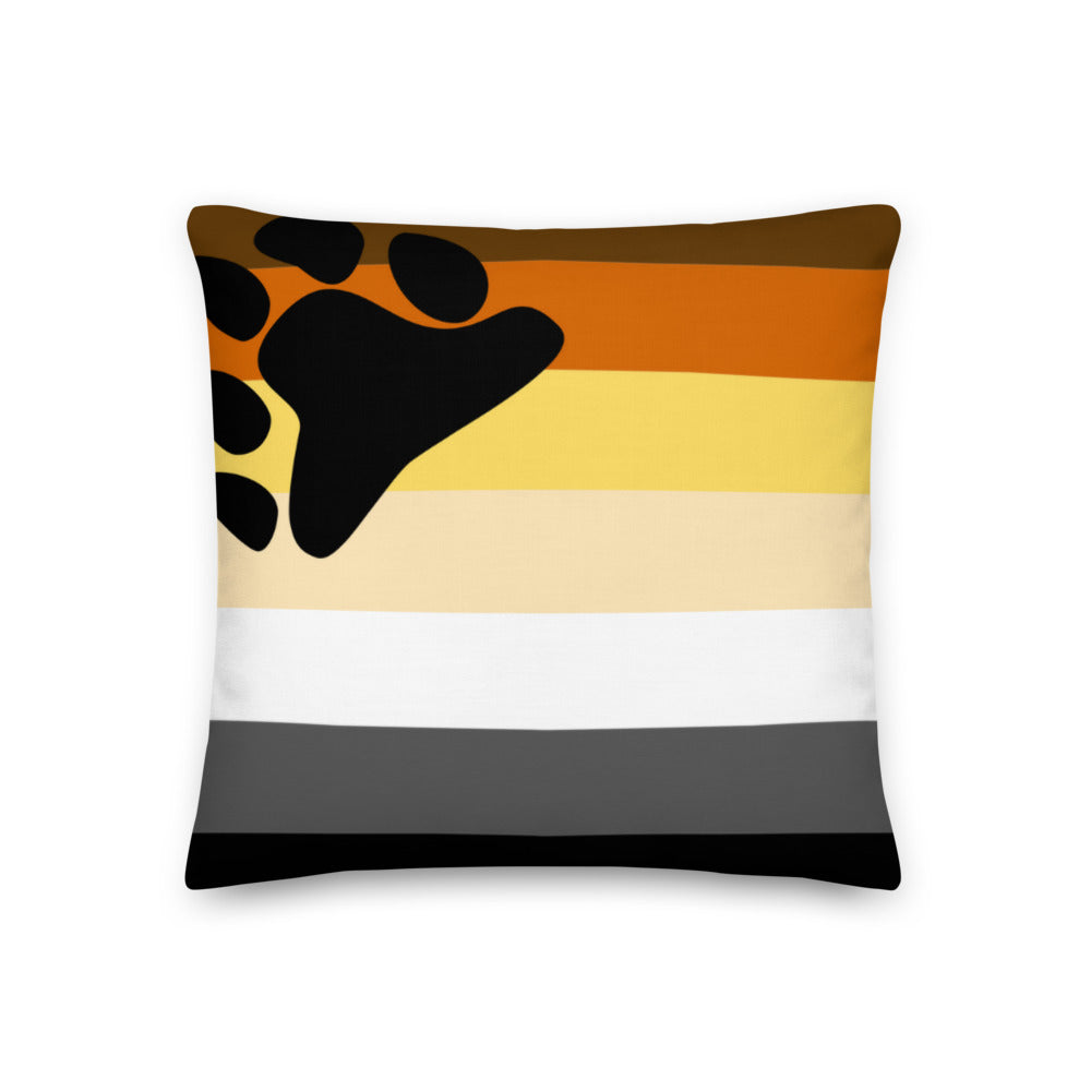 Gay Bear Pride Premium Pillow with bold horizontal stripes and a black bear paw print, on a beige sofa, bathed in warm, soft light.