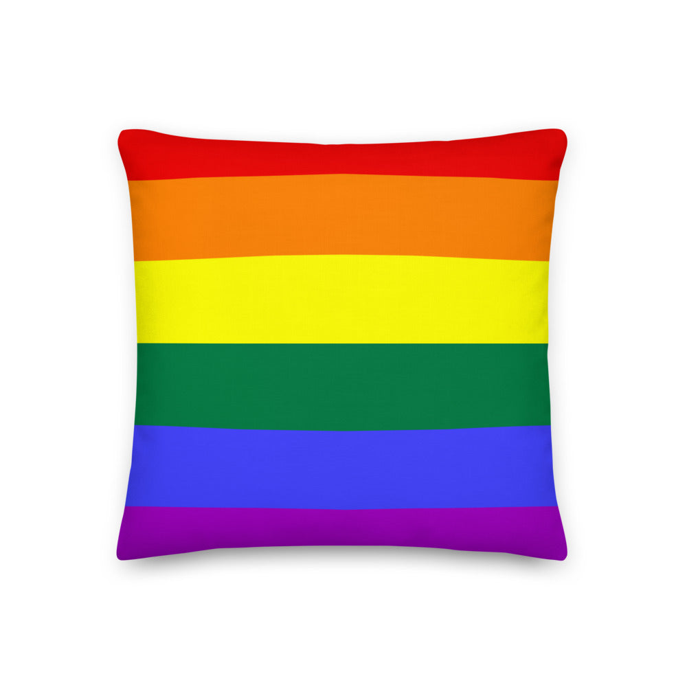 Gay Premium Pillow sits on a teal sofa with other colorful pillows; yellow armchairs, wood accents, plants, and bold queer art fill the space.