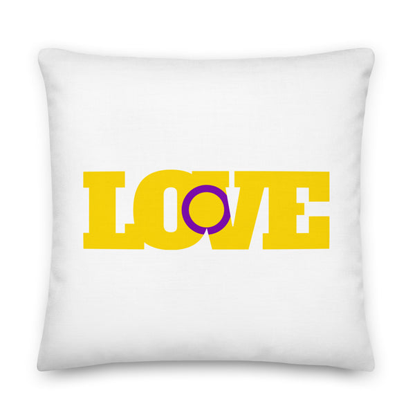 White square pillow with bold yellow and purple “LOVE” lettering on the front