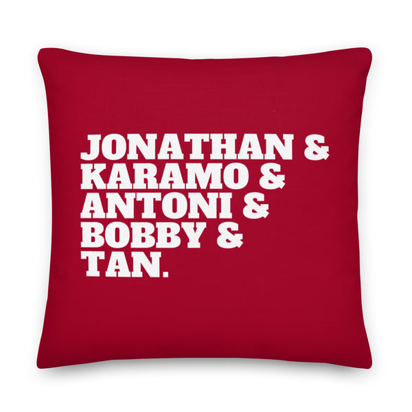 Red square pillow with bold white text reading “JONATHAN & KARAMO & ANTONI & BOBBY & TAN.”