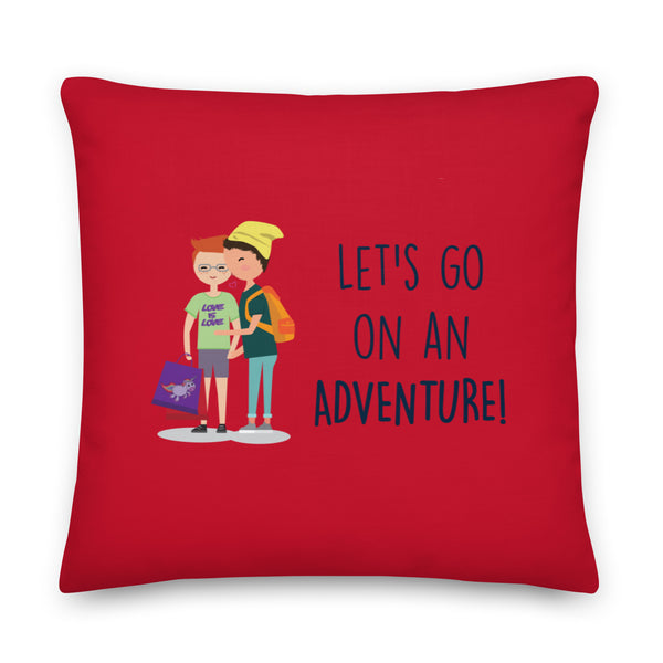 Red square pillow with two illustrated people and the words “LET’S GO ON AN ADVENTURE!”